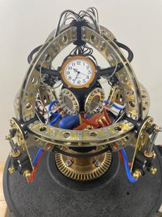 An eight-inch in diameter sculpture blending steampunk’s brass and gears with the mind-bending world of quantum physics.