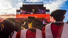 An image of three college students in graduation regalia.