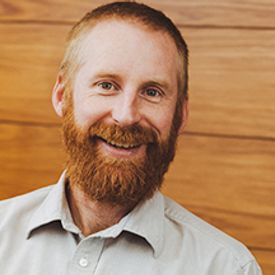 a photo of a smiling man with a beard