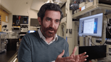 Mohammad Hafezi sits in a laboratory setting, gesturing with his hands while speaking.