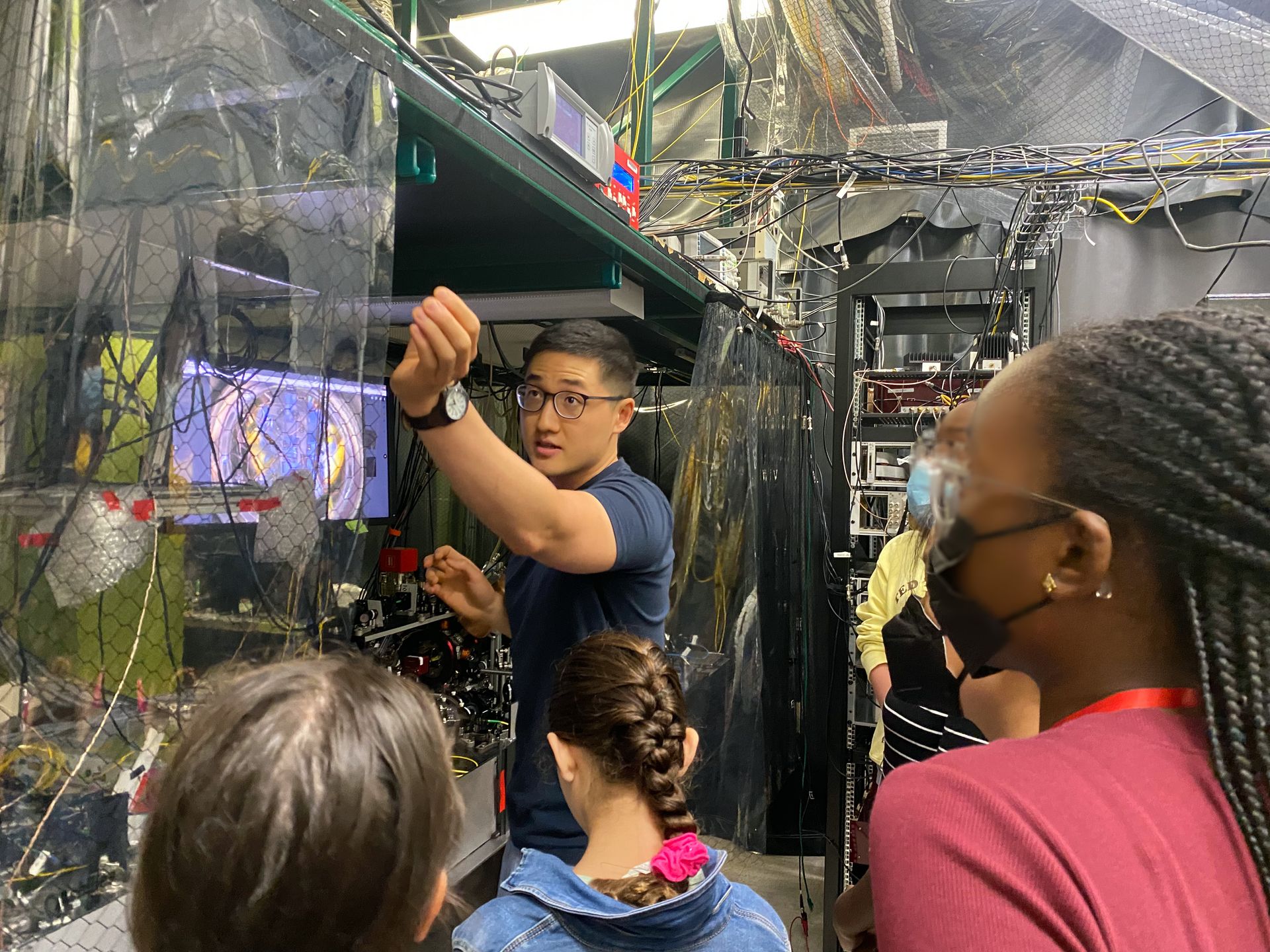 An RQS graduate student leads a lab tour for a middle school summer camp